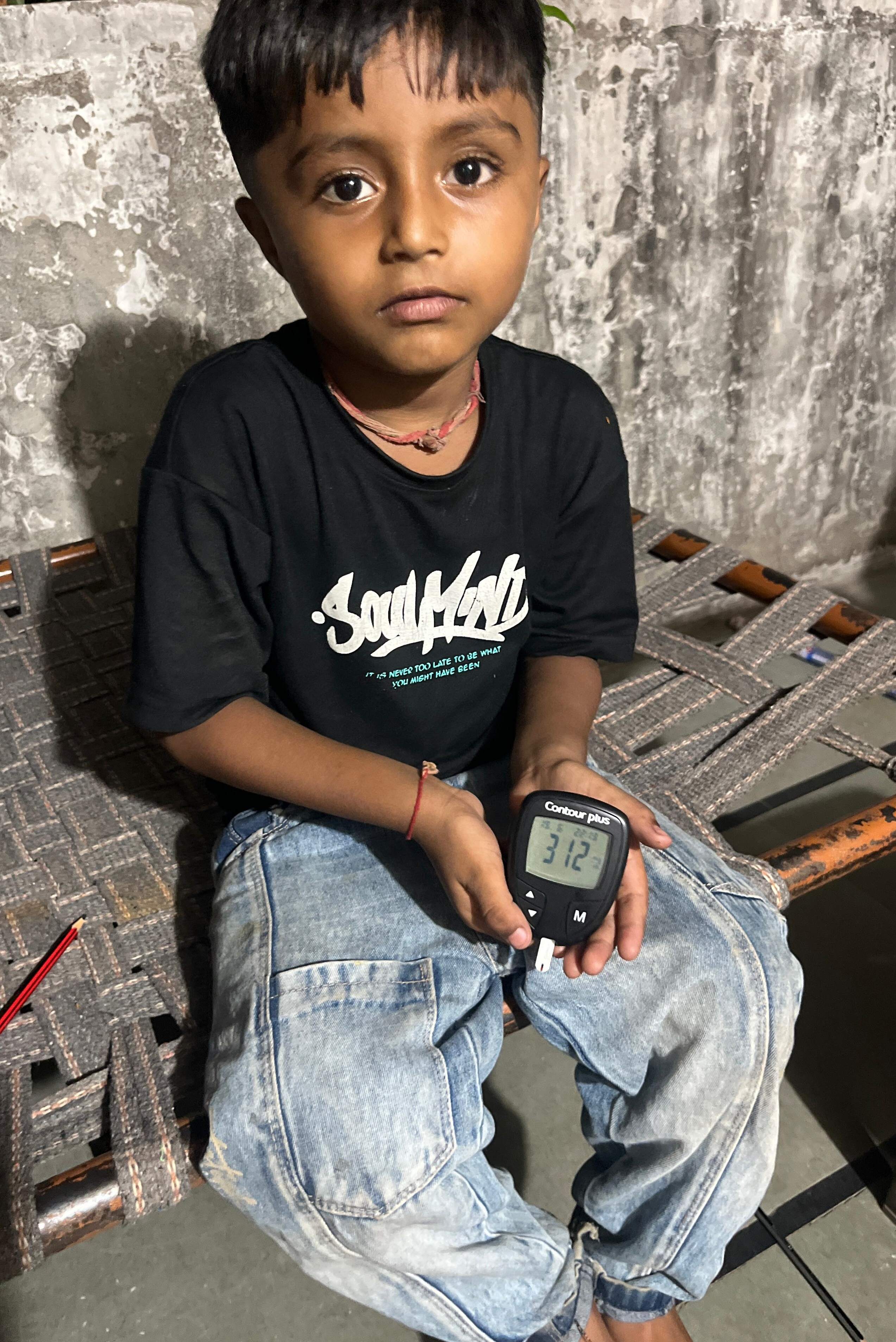 Our youngest beneficiary getting her blood sugar tested